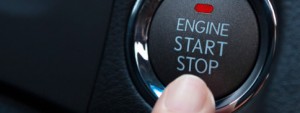 detail of a finger pushing start engine button
